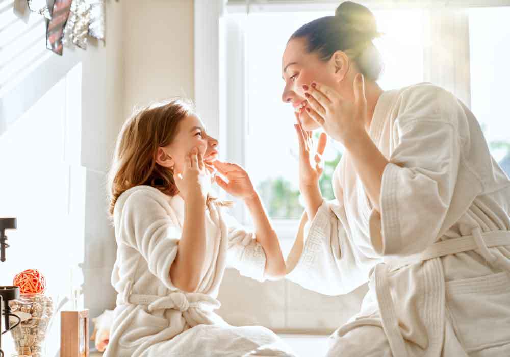 a woman and her daughter smiling after receiving skincare treatments
