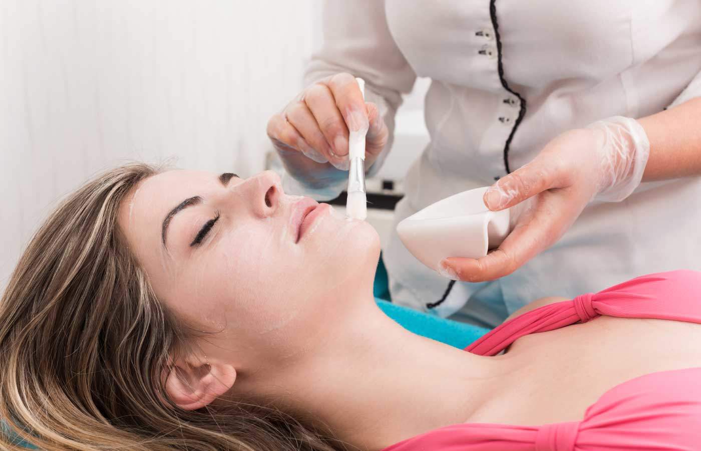 a woman receiving a chemical peel treatment