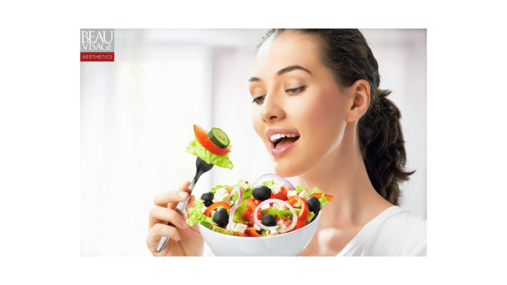 A smiling woman enjoying a bowl of fresh salad with leafy greens, tomatoes, and cucumbers, symbolizing a healthy lifestyle and nutritious eating showing healthy foods for weight loss