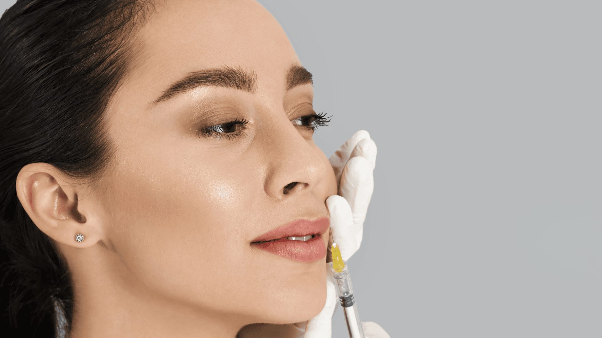 A woman receiving a lip injection from a professional in a medical spa setting, showcasing a safe and precise cosmetic procedure in Walnut creek , CA.